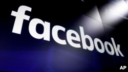 FILE - This March 29, 2018, photo shows the logo for Facebook on screens at the Nasdaq MarketSite, in New York's Times Square.