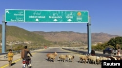 FILE - A Pakistani motorcyclist drives on a newly built Pakistan China Silk Road in Haripur, Pakistan, Dec. 22, 2017.