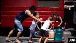 This photo taken on March 14, 2019 shows residents of Barangka, in Manila, gathering water.