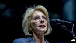 FILE - President-elect Donald Trump's pick for Education Secretary Betsy DeVos speaks during a rally at DeltaPlex Arena in Grand Rapids, Mich.