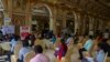 FILE - Applicants seeking employment wait to attend interviews during a job fair in Hyderabad, India, July 24, 2021.