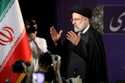 FILE - Ebrahim Raisi leaves a news conference after registering his candidacy for the June 18 presidential elections, at the elections headquarters at the Interior Ministry in Tehran, May 15, 2021.