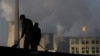 Backdrop by cooling towers of a power plant and chemical factory in China. Among the 1,200 proposed coal-fired power plants 76 percent will be built in China and India, already among the top emitters of climate changing greenhouse gases. 