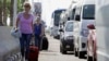 Tourists with their luggage walk towards the main entrance to the Sharm el-Sheikh airport in Egypt, Nov. 7, 2015.