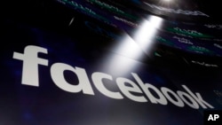 The logo for Facebook appears on screens at the Nasdaq MarketSite in New York's Times Square, March 29, 2018. 