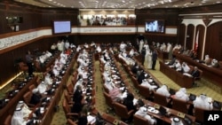 FILE- In this July 28, 2013 file photo, Bahraini lawmakers participate in a special session of parliament to discuss how to handle the uprising in the Gulf island kingdom, convened in Manama, Bahrain.