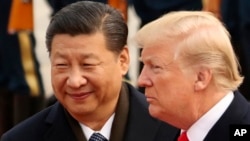 FILE - U.S. President Donald Trump and Chinese President Xi Jinping participate in a welcome ceremony at the Great Hall of the People in Beijing, China, Nov. 9, 2017.