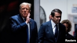 El expresidente estadounidense Donald Trump (izq.) habla con el abogado Todd Blanche cuando regresa de una pausa para almorzar en el tribunal penal de Manhattan mientras continúa la selección del jurado en la ciudad de Nueva York, el jueves 18 de abril de 2024.