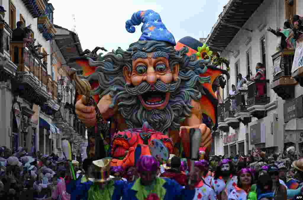 Artists perform with traditional floats during the "Blacks and Whites" carnival parade in Pasto, Colombia, Jan. 6, 2025.