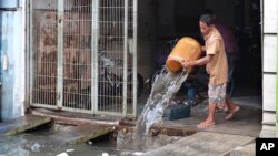 A man cleans his flood-damaged house in Jakarta, Indonesia, Jan. 5, 2020. 