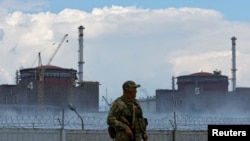 FILE PHOTO: A serviceman with a Russian flag on his uniform stands guard near the Zaporizhzhia Nuclear Power Plant in the course of Ukraine-Russia conflict outside the Russian-controlled city of Enerhodar in the Zaporizhzhia region, Ukraine August 4, 2022