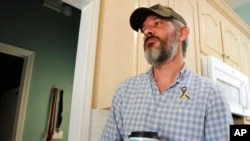 Alex Drueke, recently released from three months of Russian captivity, pauses during an interview at home in Tuscaloosa, Ala., on Sept. 30, 2022.