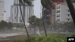 A man walks along the beach following the passage of typhoon Noru in Danang on September 28, 2022. 