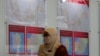 A staff member from Malaysia's Election Commission walks past a map showing state assembly areas at its office in Putrajaya, Malaysia, Oct. 20, 2022.