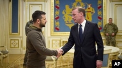 Ukrainian President Volodymyr Zelenskyy, left, and White House national security adviser Jake Sullivan shake hands during their meeting in Kyiv, Ukraine, Nov. 4, 2022. (Ukrainian Presidential Press Office via AP)