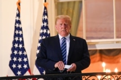 U.S. President Donald Trump poses on the Truman Balcony of the White House after returning from being hospitalized at Walter Reed Medical Center for coronavirus disease (COVID-19) treatment, in Washington, Oct. 5, 2020.