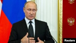 Russian President Vladimir Putin speaks during a joint news conference with Hungarian Prime Minister Viktor Orban following their talks at the Kremlin in Moscow, Sept. 18, 2018.