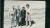 The black and white group photograph shows Richard Dudman (far left), Malcolm Caldwell (far right) and Elizabeth Becker (center left), with Commander Pin (center right), a senior Khmer Rouge military figure, near the eastern border with Vietnam preparing for war. (Courtesy photo of Elizabeth Becker)