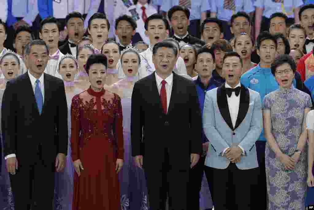 在维多利亚港的香港会展中心举行的庆祝香港主权回归中国20周年的文艺晚会上,中国最高领导人习近平以及香港特首梁振英、当选特首林郑月娥和甄子丹等演员们合唱《歌唱祖国》(2017年6月30日)。
