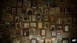 FILE - Pictures of Yazidis slain in 2014 by Islamic State militants are found in a small room at the Lalish shrine in northern Iraq, Sept. 12, 2019.