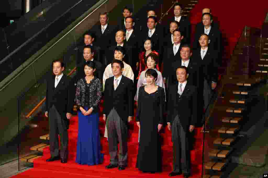 Japan's Prime Minister Shinzo Abe (front row center) and his new cabinet members pose for a group photo following the first cabinet meeting at the prime minister's official residence, in Tokyo, Sept. 3, 2014.