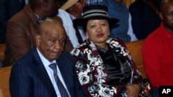 Lesotho's Prime Minister Thomas Thabane, left, and his wife Maesaiah, right, appear in court in Maseru, Feb. 24, 2020.