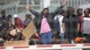 Refugees and migrants most of them from Pakistan protest against EU-Turkey deal about migration inside the entrance of Moria camp in the Greek island of Lesbos on April 5, 2016. 