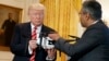 George Mathew, CEO of Kespry, shows a drone to President Donald Trump during the "American Leadership in Emerging Technology" event in the East Room of the White House, June 22, 2017, in Washington.