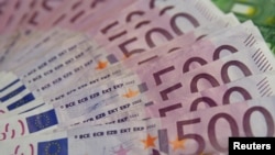 FILE - A photo illustration shows euro banknotes, Jan. 26, 2015. 