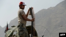 An Afghan border policeman takes position following clashes with Pakistani forces on the border between Afghanistan and Pakistan in eastern Nangarhar province, June 15, 2016.