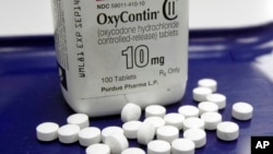 FILE - OxyContin pills are displayed at a pharmacy in Montpelier, Vt.