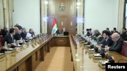 Iraqi Prime Minister Haider al-Abadi attends a meeting with officials in Baghdad, Iraq, Aug. 28, 2018.