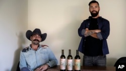 In this Dec. 22, 2017, photo, Alex Howe, right, and Chip Forsythe, co-founders of Rebel Coast, pause for photos with their cannabis-infused wine in Los Angeles.
