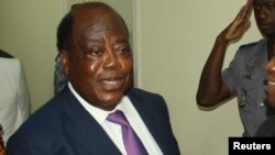 Charles Konan Banny (L), independent candidate for the 2015 presidential election, shakes hands with Independent Electoral Commission (CEI) President Youssouf Bakayoko (R) after registering his candidacy for the presidential election in Abidjan, Ivory Coa