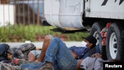 Solicitantes de asilo en México se refugian debajo de un camión en Monterrey, el pasado 12 de junio.