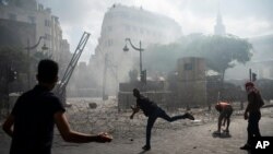 People clash with police during a protest against the political elites and the government after this week's deadly explosion at Beirut port which devastated large parts of the capital and killed more than 150 people, in Beirut, Lebanon, Aug. 8, 2020.