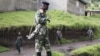 A M23 rebel fighter stands guard as they prepare for withdrawal from Karuba, some 62 kilometers west of Goma, DRC, November 28, 2012. 