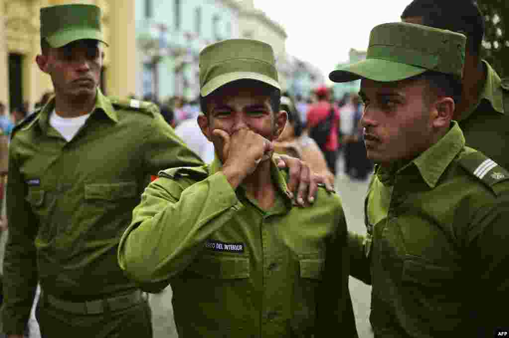 Para tentara Kuba menangis saat kendaraan yang membawa abu kremasi jenazah Fidel Castro melalui kota Santa Clara, Kuba.