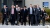 Syrian opposition chief negotiator Hadi al-Bahra (2nd R) and General Secretary of the Syrian National Council Badr Jamous (4ht R) arrive with the opposition delegation to attend a meeting at the "Geneva II" peace talks dedicated to the ongoing conflict in in Syria, in Geneva, Jan. 25, 2014.