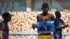 A man holds a photograph of Supreme Court Judge Joseph Mecene Jean-Louis during protests against Haiti's President Jovenel Moise, in Port-au-Prince, Haiti, Feb. 8, 2021. 