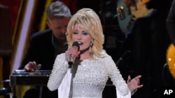 FILE - This Nov. 13, 2019, file photo shows Dolly Parton performing at the 53rd annual CMA Awards in Nashville, Tennessee. 