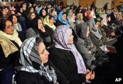 Afghan women listen to Afghan President Hamid Karzai, during a speech about women's rights, in Kabul (File)