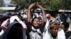 FILE - Women mourn during the funeral ceremony of Dinka Chala, a primary school teacher who family members said was shot dead by military forces during a recent demonstration, in Holonkomi town, in Oromia region of Ethiopia, Dec. 17, 2015.