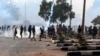 Sudanese protesters gather amid tear gas fired by security forces on al-Qasr street, during a demonstration against the Oct. 25 coup, in the capital Khartoum, Jan. 2, 2022. 