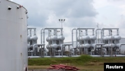 FILE - An oil storage tank and crude oil pipeline equipment is seen at the Strategic Petroleum Reserve in Freeport, Texas, U.S., June 9, 2016.