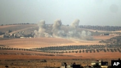 Smoke rises from the Syrian side of the border, in a photo taken from Karkamis, Turkey, Aug. 24, 2016. 