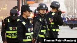 China-Armed police keep watch in a street in Kashgar, Xinjiang Uighur Autonomous Region, China, March 24, 2017. REUTERS/Thomas Peter/File Photo