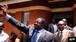 FILE - A November 14, 2013 photo outside Lilongwe's High Court shows Malawi's Democratic Progressive Party President and winner of the presidential election Peter Mutharika (C), as he waves to his supporters. 