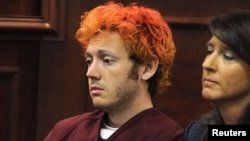 Colorado shooting suspect James Eagan Holmes (L) sits with public defender Tamara Brady during his first court appearance in Aurora, Colorado, July 23, 2012.