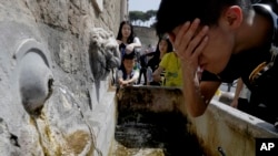 Tourists refresh themselves at a fountain in Rome, Aug. 9, 2017. 
